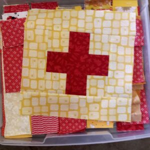 Scrappy plus blocks and fabric in project box