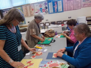 Quilters in a classroom working on quilts.