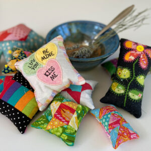 Patchwork pin cushions with a bowl of lavender