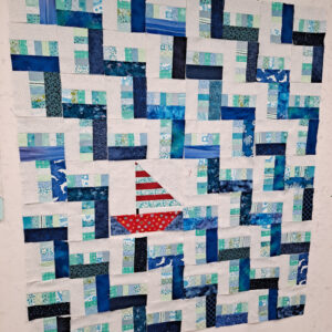 Rail fence quilt with sailboat on design wall