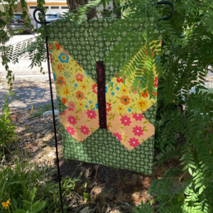 Patchwork butterfly garden flag in a xeriscape garden