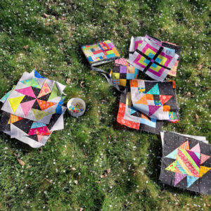 Bright, colorful quilt blocks on a lawn