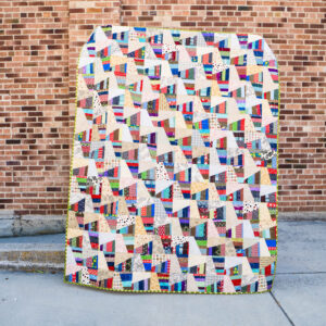 Wonky rail fence quilt made from scrappy strips.