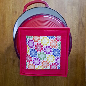Quilted hot pad on cast iron pot.