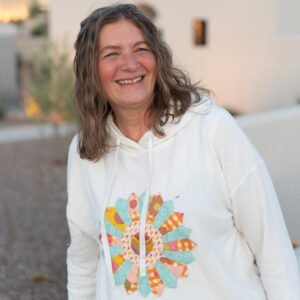 Girl wearing white sweatshirt with applique