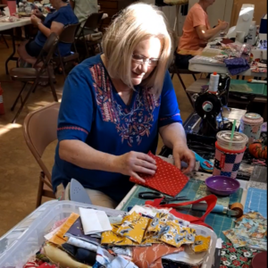 Quilter sewing with fabric scraps