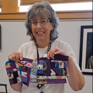 Quilter showing off their crumb quilt blocks