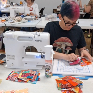 Quilter sewing crumb quilt blocks 