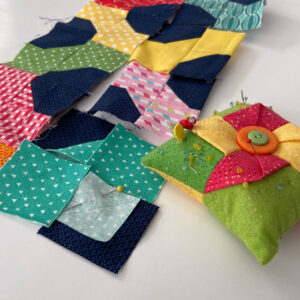 Colorful Scrappy bowtie quilt blocks with pincushion