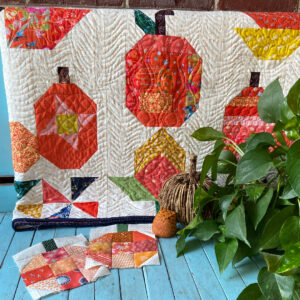 Fall quilt draped over a bench 