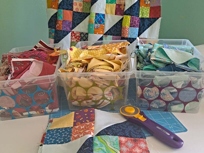 Jacob's ladder scrap quilt and block with red, yellow and blue scrap bins