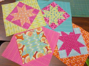 Scrappy maverick star quilt blocks set on point