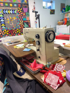 Sewing space with quilt on design wall.