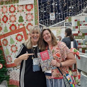 Moda Lissa excited about Aunt Em's new book at quilt market.