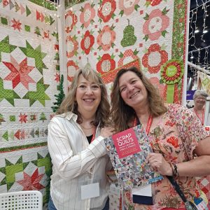 Sheri and Aunt Em at A Quilting Life's booth at quilt market