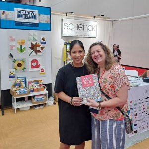 Emily Bailey from Aunt Em's Quilts presenting her new book at EE Schenck's booth at market.