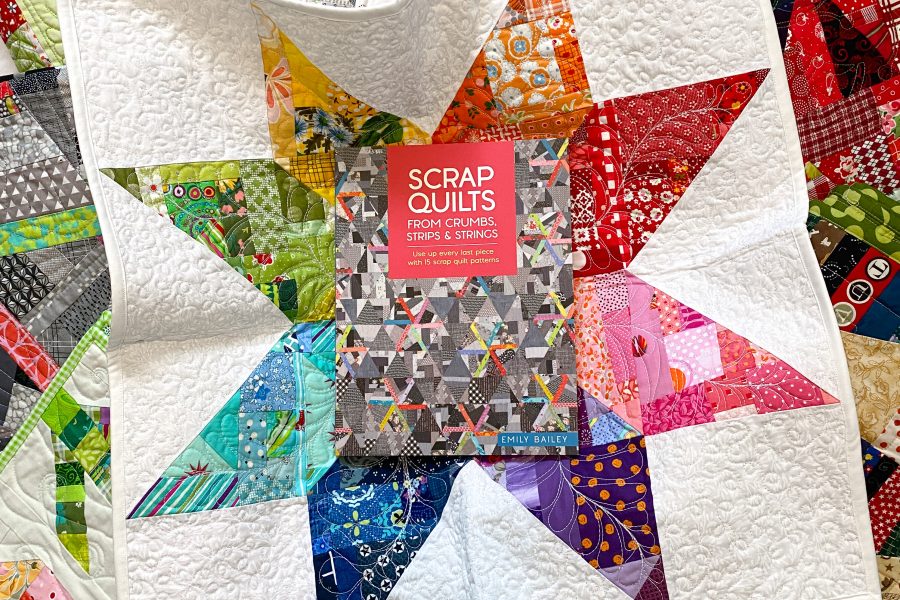 Scrap Quilt book in center of crumb star quilt.