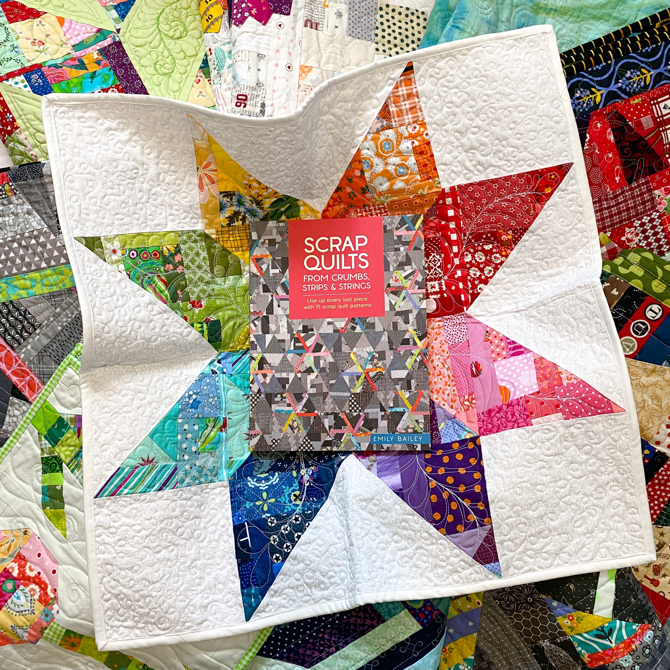 Scrap Quilt book in center of crumb star quilt.