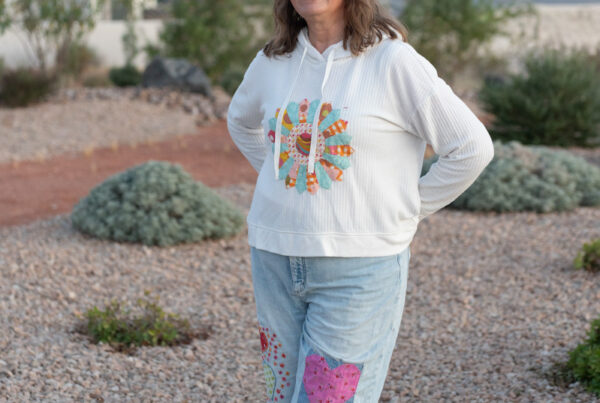 Girl wearing thrifted sweatshirt with applique and upcycled jeans