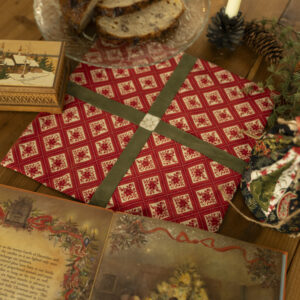 small table decorated with Christmas table topper and other holiday decor