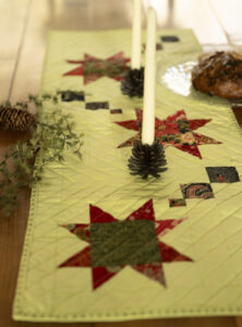 Christmas star table runner set on table with candles and decor